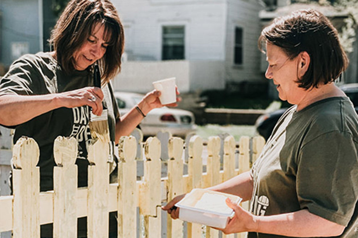 Culture and Careers - Two Woman Volunteers Painting a Fence Larger